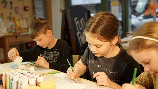 children-painting-pottery-together